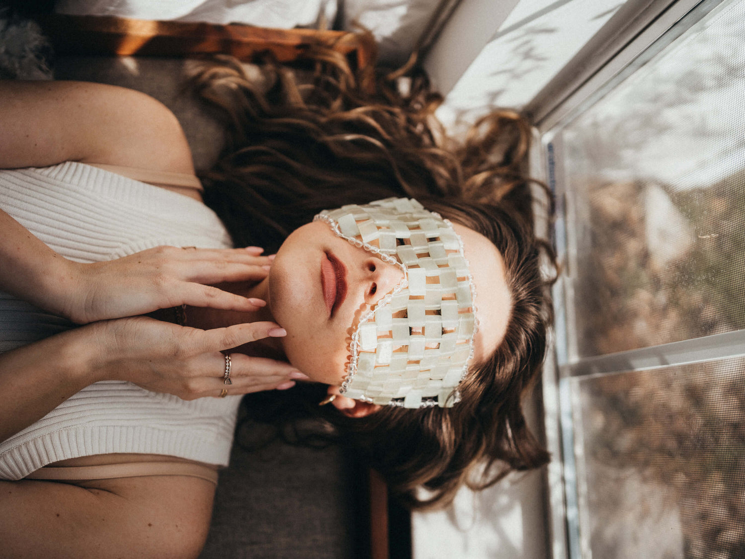 Woman relaxing with gemstone face mask for spas in Birmingham, AL.